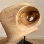 hand carved walnut wood sculpture detail smooth surface flowing grain inner opening