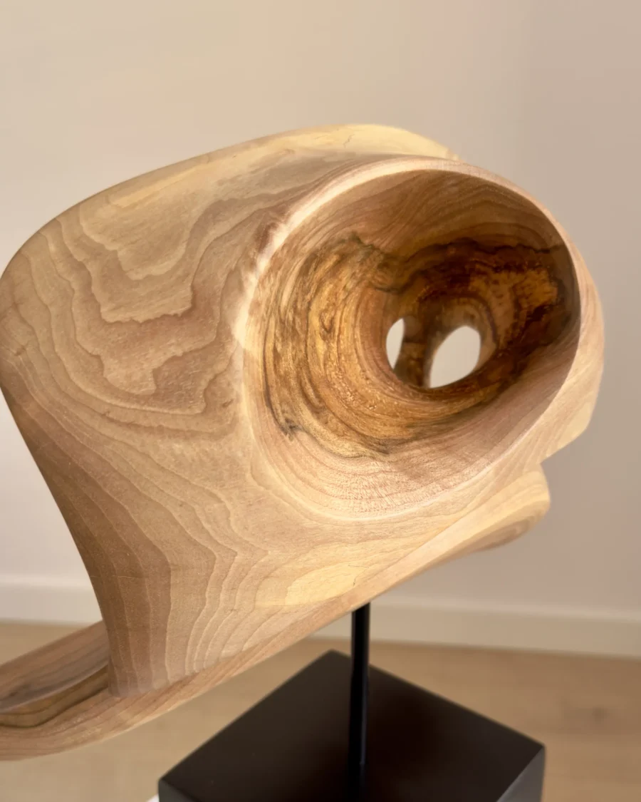 hand carved walnut wood sculpture detail smooth surface flowing grain inner opening