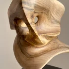 abstract wood sculpture detail walnut grain opening light smooth carved form