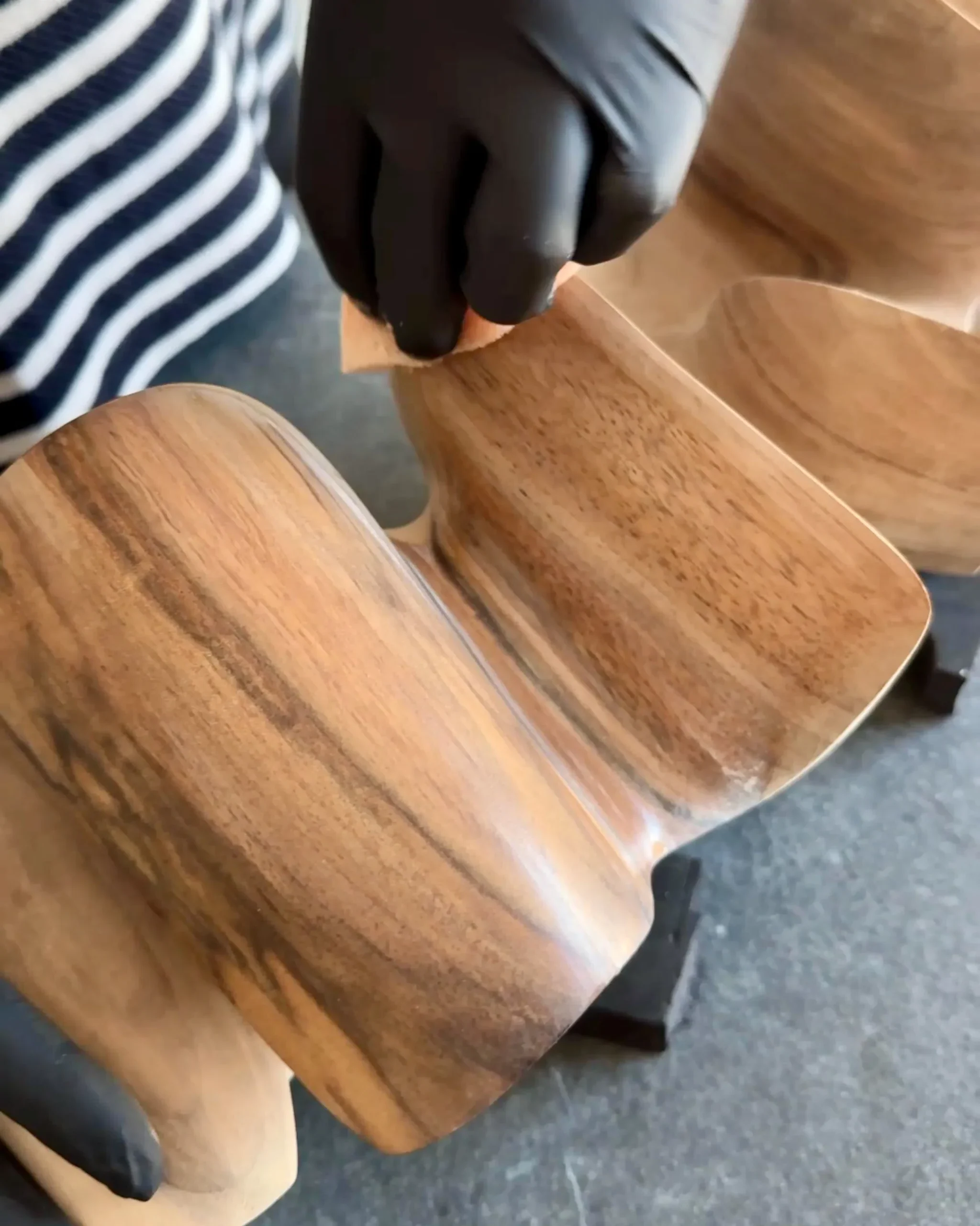 applying wax to wooden sculpture, finishing walnut wood surface