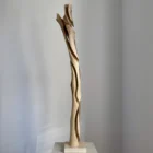 full view tall abstract wood sculpture walnut on pedestal minimalist space unfolding form