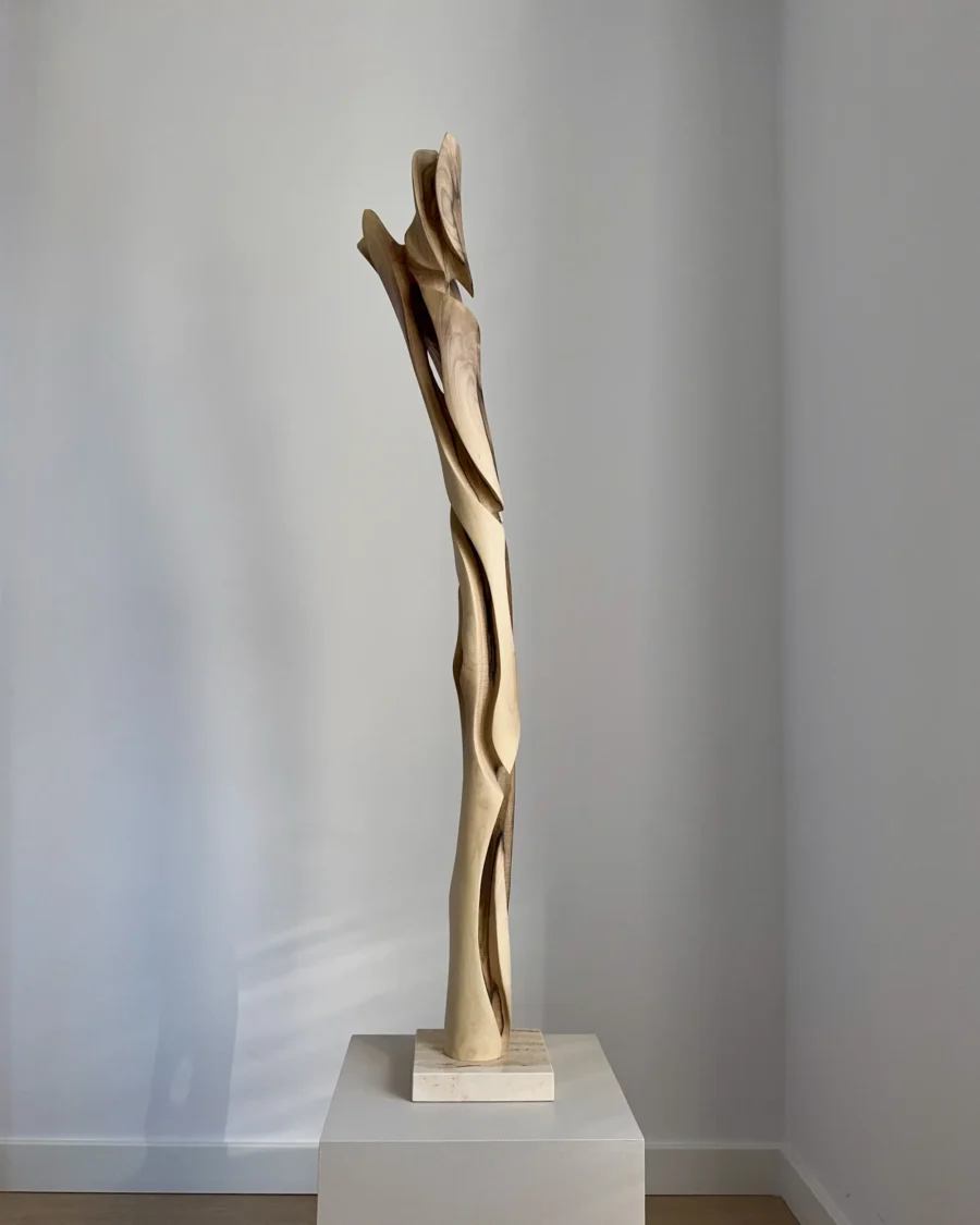 full view tall abstract wood sculpture walnut on pedestal minimalist space unfolding form