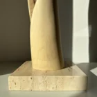 wood sculpture base travertine stone detail natural materials minimalist sculpture unfolding form