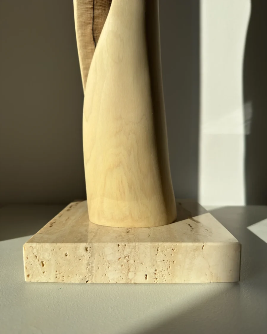 wood sculpture base travertine stone detail natural materials minimalist sculpture unfolding form