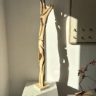 abstract wood sculpture in walnut hand carved tall organic form with light and shadow unfolding form