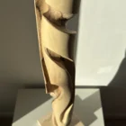 hand carved wood sculpture detail flowing transitions organic shape walnut unfolding form