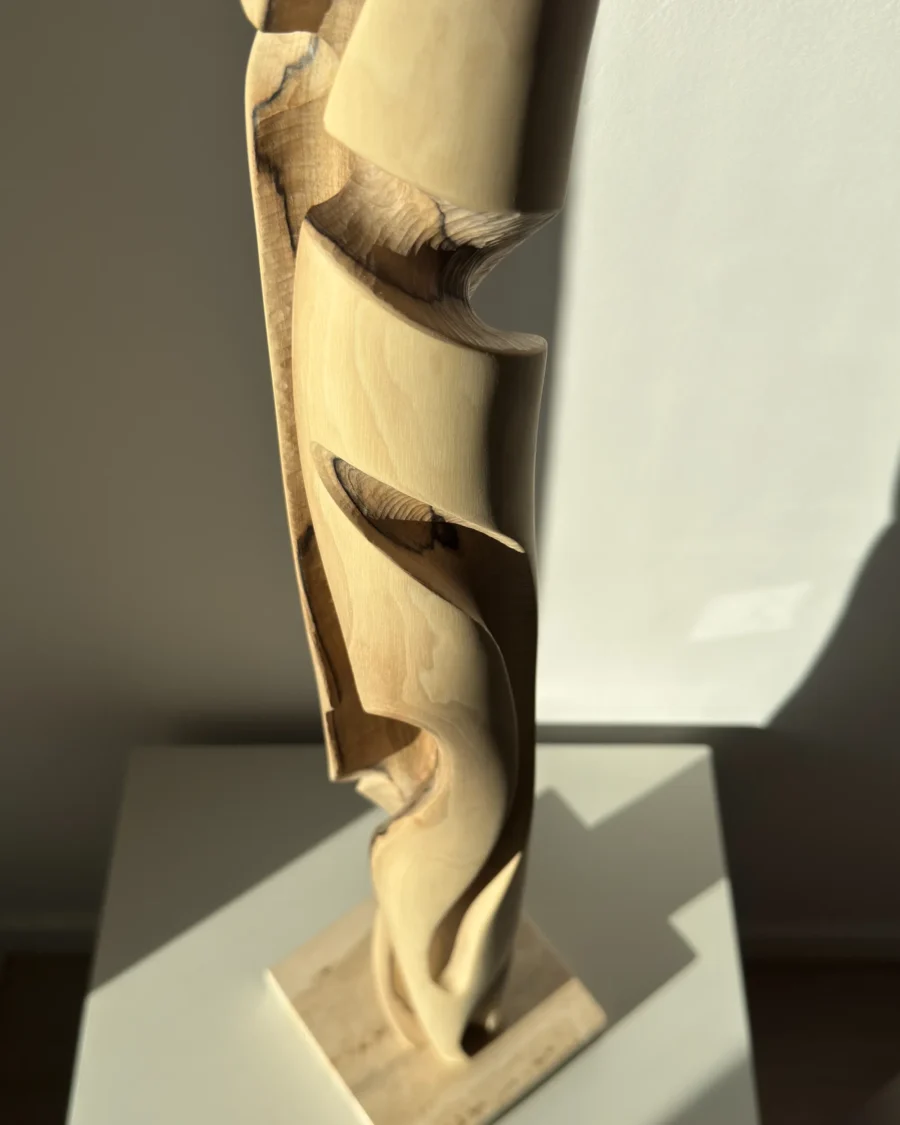 hand carved wood sculpture detail flowing transitions organic shape walnut unfolding form