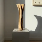 Abstract walnut wood vase, hand-carved from solid wood, tall organic sculptural form in natural light