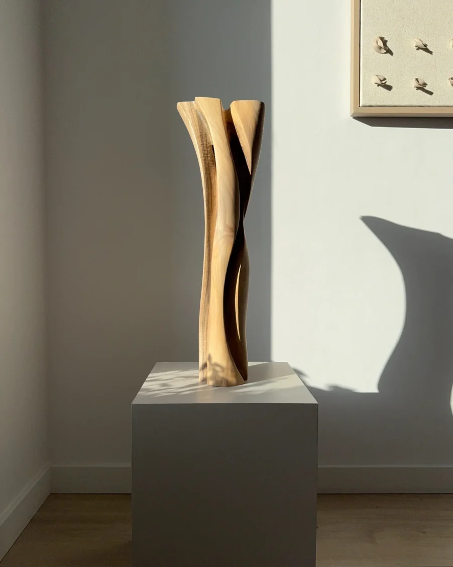 Abstract walnut wood vase, hand-carved from solid wood, tall organic sculptural form in natural light