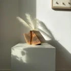wood sculptural vase walnut held fold hand carved vase with dried pampas in natural light
