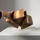 hand holding walnut sculptural vase showing scale and size handmade object