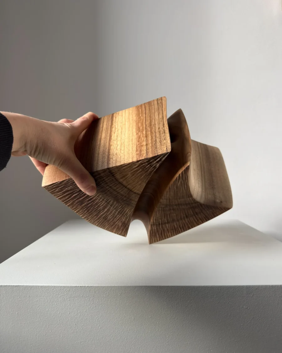 hand holding walnut sculptural vase showing scale and size handmade object