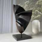 abstract wood sculpture in interior setting applewood sculpture with flowers on table modern space