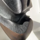 close up abstract wood sculpture carved interior dark textured surface shadow split detail