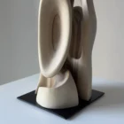 Abstract walnut sculpture Ivory Flow mounted on black steel base detail view