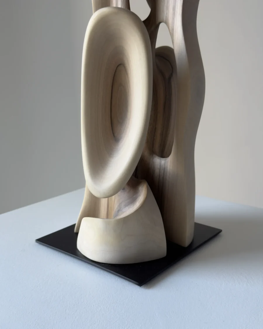 Abstract walnut sculpture Ivory Flow mounted on black steel base detail view