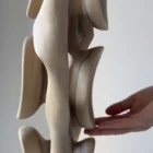 Top section of Ivory Flow sculpture showing sculpted openings and flowing organic lines