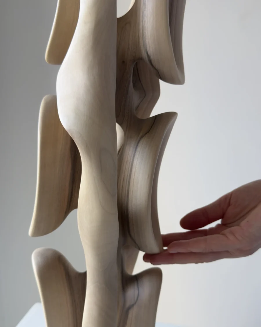 Top section of Ivory Flow sculpture showing sculpted openings and flowing organic lines