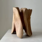 modern abstract wood sculpture with curved planes and natural grain, hand carved walnut, changing form from different angles
