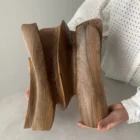 hand holding abstract wooden sculpture for scale, hand carved walnut art piece size reference