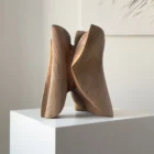 abstract wooden sculpture hand carved from solid walnut, organic flowing form on pedestal, modern minimalist wood art