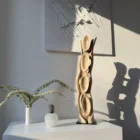Hand carved walnut sculpture Ivory Flow with organic openings casting dynamic shadows in interior