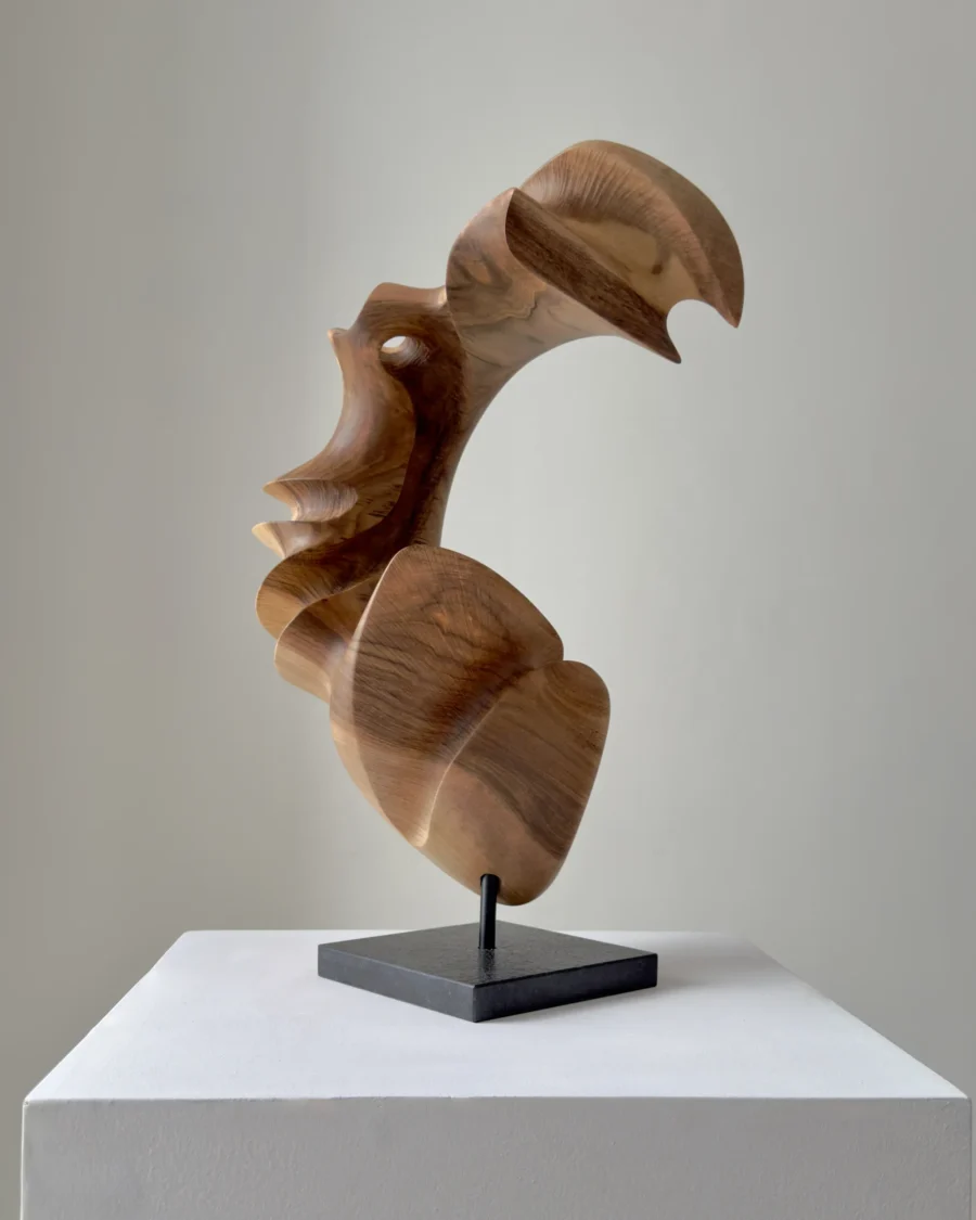 Organic wood sculpture with open form and natural grain, hand-carved from solid walnut
