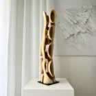 Back view of Ivory Flow sculpture showing continuous organic structure carved from solid walnut
