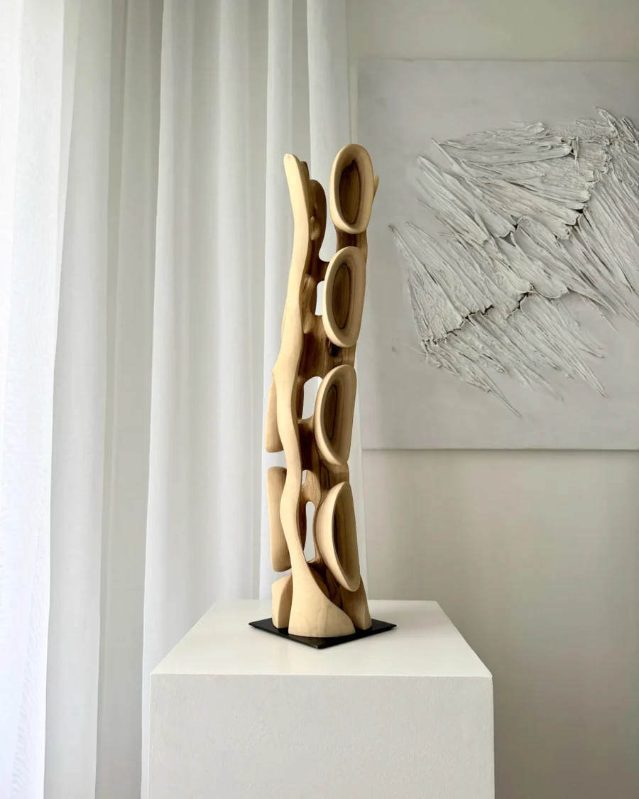 Back view of Ivory Flow sculpture showing continuous organic structure carved from solid walnut