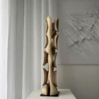 Minimalist walnut wood sculpture Ivory Flow in soft daylight revealing smooth hand carved surface