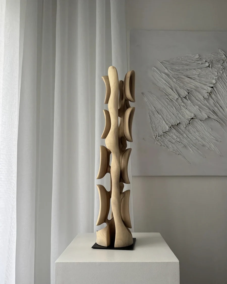 Minimalist walnut wood sculpture Ivory Flow in soft daylight revealing smooth hand carved surface
