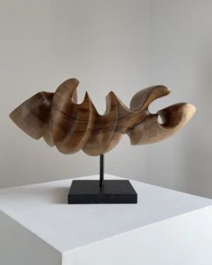 Abstract wood sculpture "Point of Hold" in walnut, front view showing smooth curved planes and light natural tones on granite base