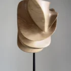 Modern abstract wood sculpture in walnut, full view showing balanced asymmetrical form and clean lines