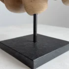 Close up of walnut wood sculpture highlighting deep natural grain patterns and sculpted curved surfaces