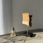 Side view of abstract walnut sculpture Velora highlighting curved organic silhouette