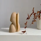 abstract pear wood sculpture Seed Form minimalist form on white pedestal -Ewebohome