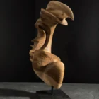 Abstract wood sculpture "Quiet Arc" in aged walnut on black granite base, hand-carved organic form with flowing curves