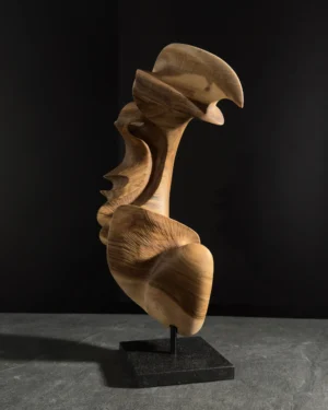 Abstract wood sculpture "Quiet Arc" in aged walnut on black granite base, hand-carved organic form with flowing curves