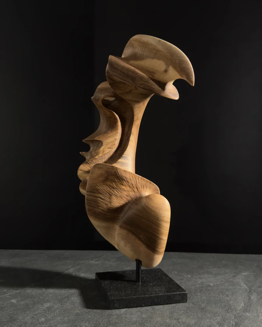 Abstract wood sculpture "Quiet Arc" in aged walnut on black granite base, hand-carved organic form with flowing curves