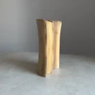 Side view of sculptural walnut vase, smooth carved surface and natural wood pattern
