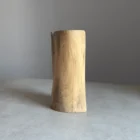 Side view of sculptural walnut vase, smooth carved surface and natural wood pattern