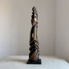 abstract sculpture with central void black wood side view