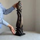 scale view hand holding wooden sculpture size reference