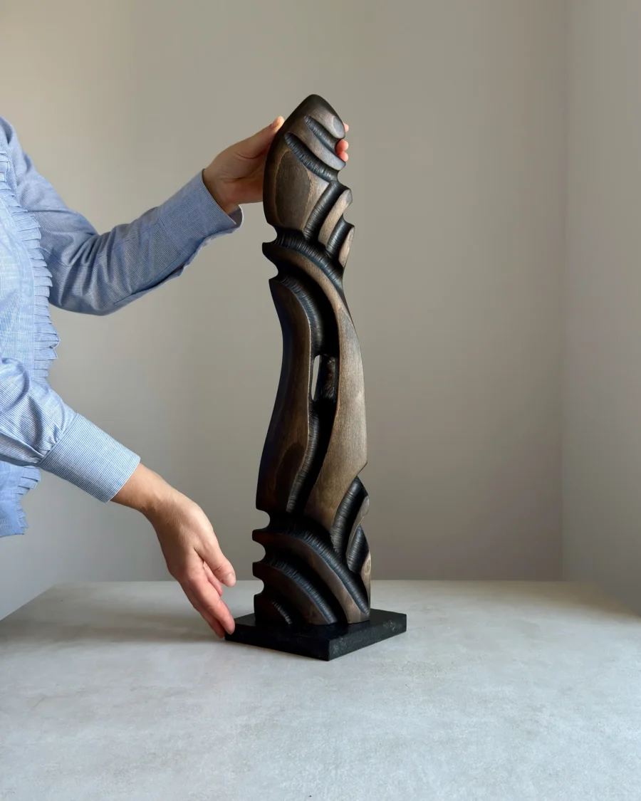 scale view hand holding wooden sculpture size reference