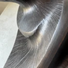 close-up of carved wood texture with black wax and light reflections