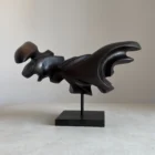 asymmetrical wooden sculpture black wax side view flowing form
