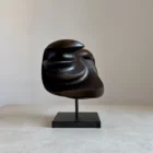 modern black wood sculpture on granite base