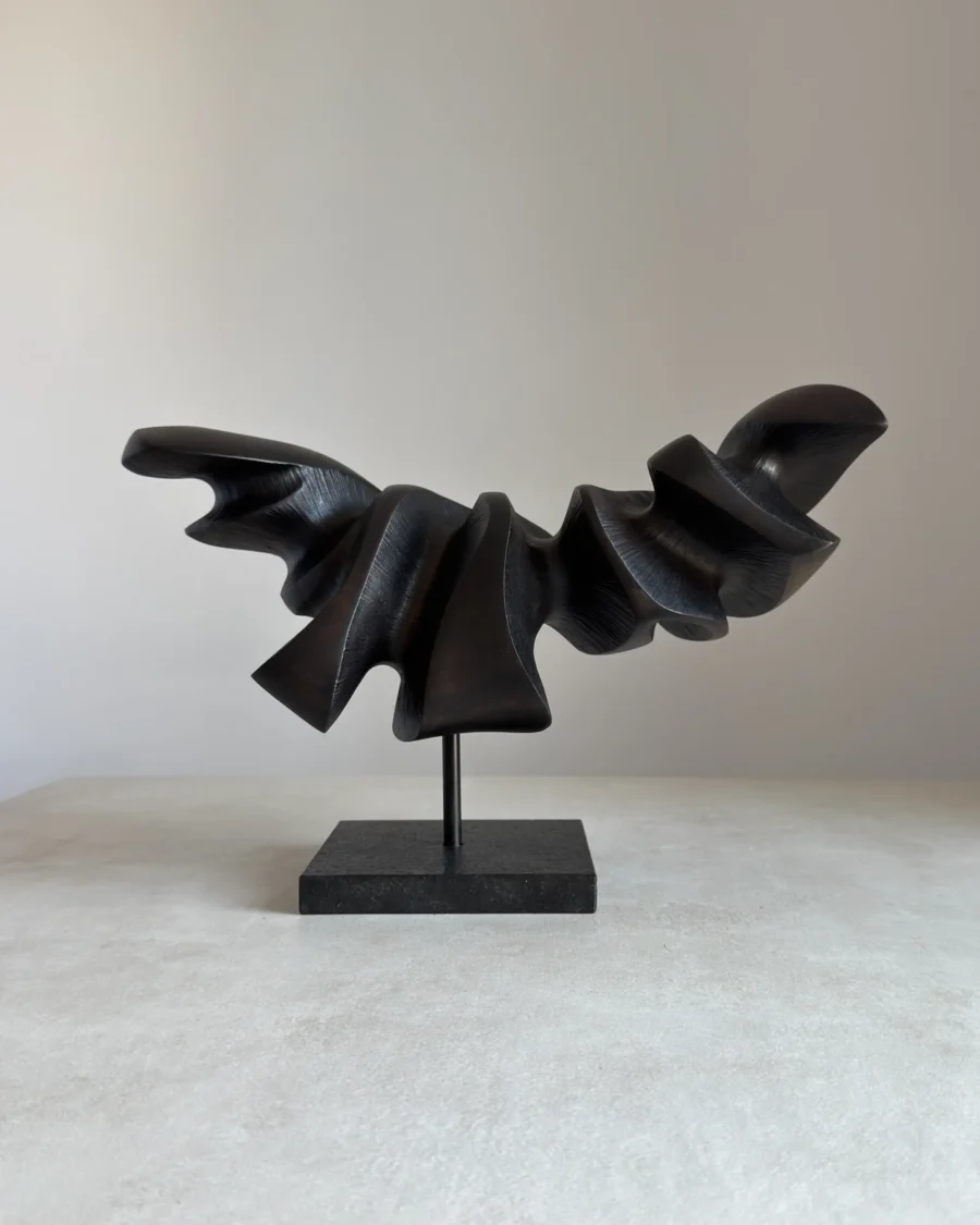 abstract wood sculpture black pear wood on granite base front view