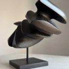 close-up of carved wood texture with black wax and light reflections