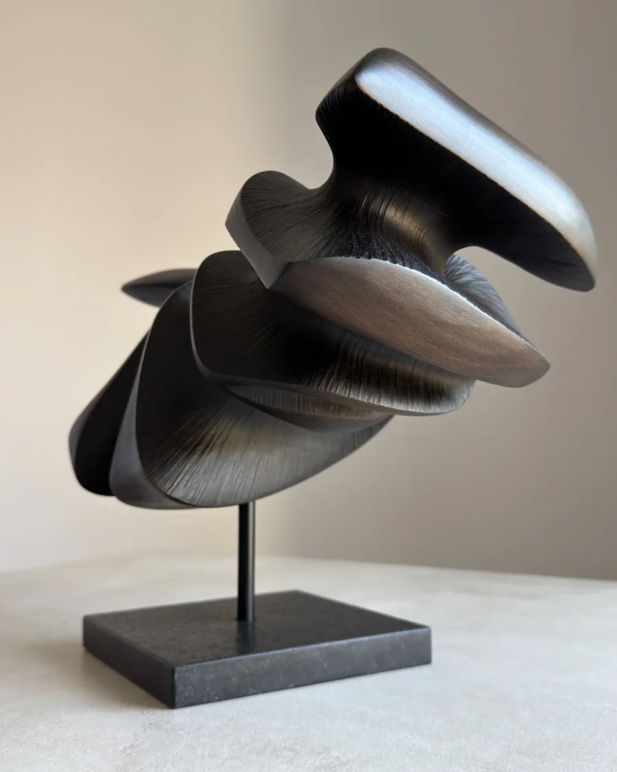 close-up of carved wood texture with black wax and light reflections